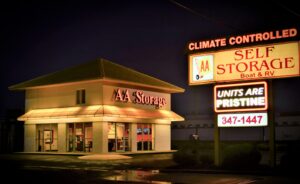 AA Self Storage office building and illuminated sign at night in Jacksonville NC highlighting climate controlled units
