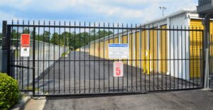 secure black gated entry with welcome sign and speed limit sign at AA Self Storage facility in Jacksonville NC