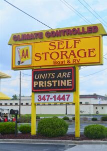 large yellow AA Self Storage sign advertising climate controlled units, pristine condition, and phone number at the Jacksonville NC facility