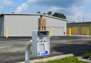 secure gate keypad entry system with storage buildings in the background at AA Self Storage in Jacksonville NC